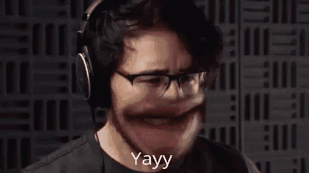 a man wearing headphones and glasses is making a funny face with his mouth wide open .