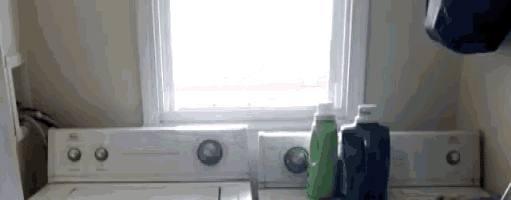 a laundry room with a washer and dryer and bottles of laundry detergent