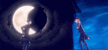 a couple of people standing in front of a full moon