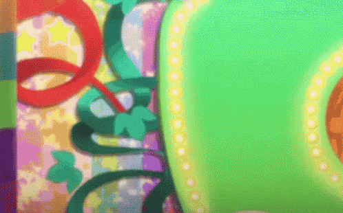 a colorful background with a green object in the center