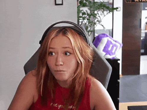 a woman wearing headphones and a red shirt that says " i do n't know " on it