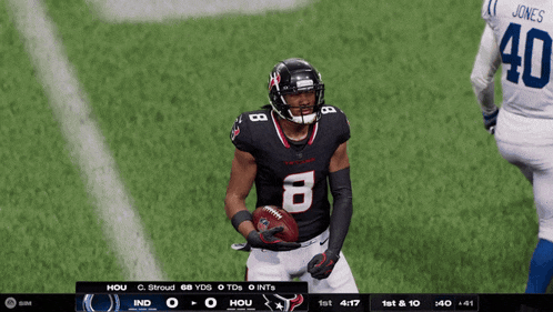 a football player with the number 8 on his jersey stands on the field