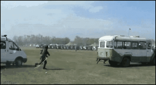 a man is running towards a bus in a field with 4gifs.com written on the bottom of the screen