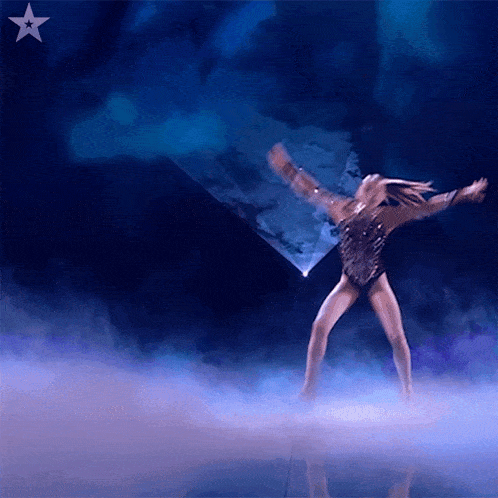 a woman is dancing on a stage with a star in the corner