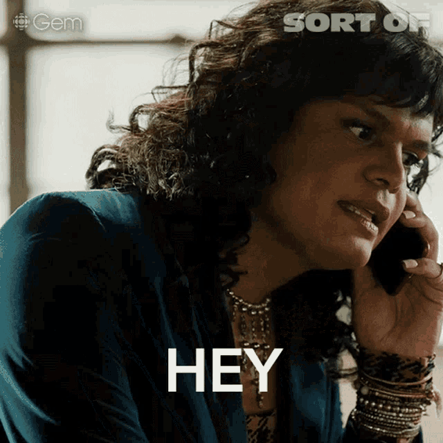 a woman is talking on a cell phone and the word hey is on the screen