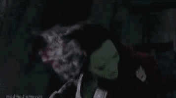 a close up of a person 's face with a purple glow coming out of it .
