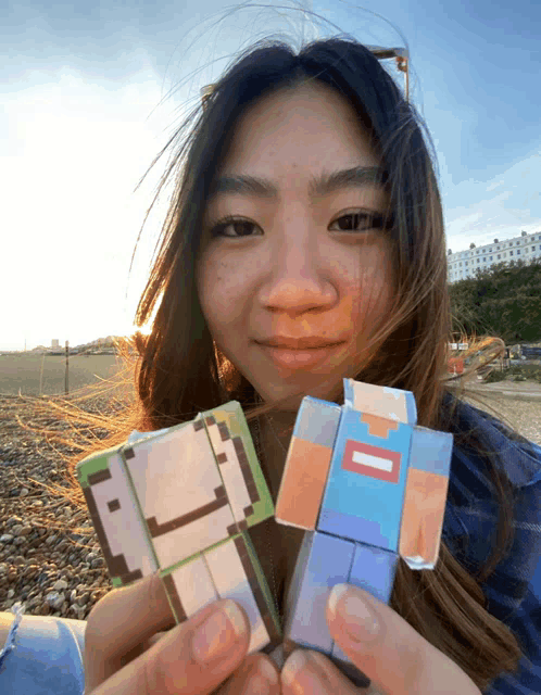 a woman is holding two minecraft figures one of which says dream