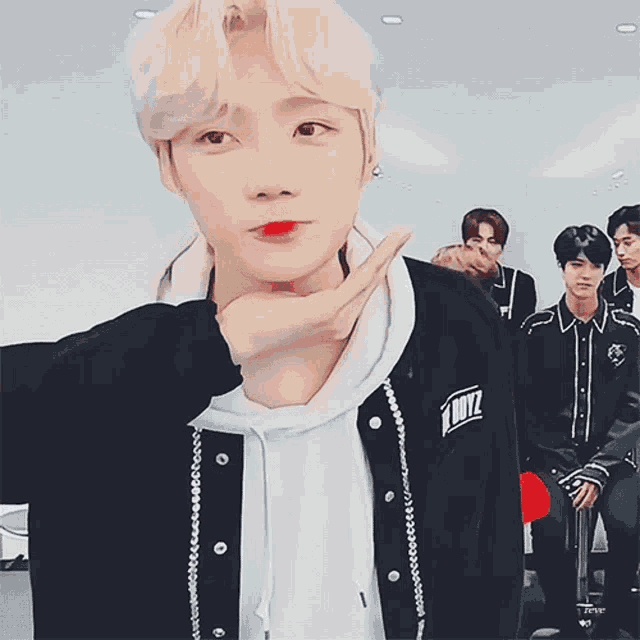 a boy wearing a black jacket that says boyz on it