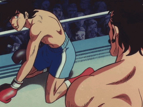 a man in a boxing ring with a crowd watching