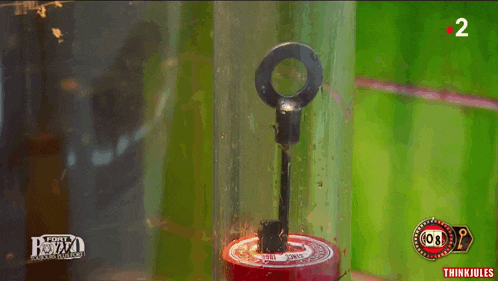 a key is in a glass container with the number 2 on it