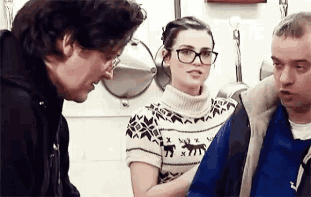 a man and a woman are standing next to each other in a kitchen .