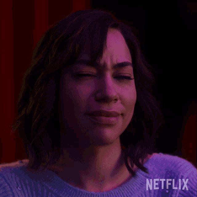 a close up of a woman 's face with a netflix logo behind her
