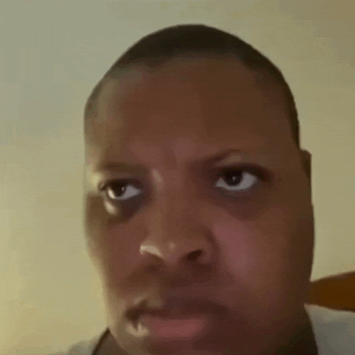 a close up of a man 's face with his eyes closed and his mouth open .