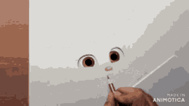 a person is drawing a face with a brush and the words made in animatica are on the bottom right
