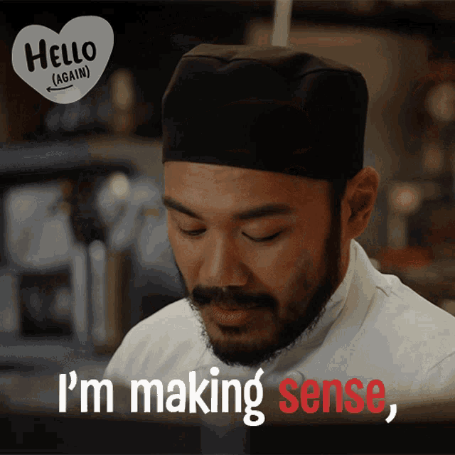 a chef says i 'm making sense in front of a hello again sign