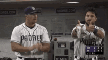 two padres players giving a thumbs up in the dugout
