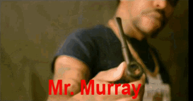 a man holding a pipe with the name mr. murray written on it