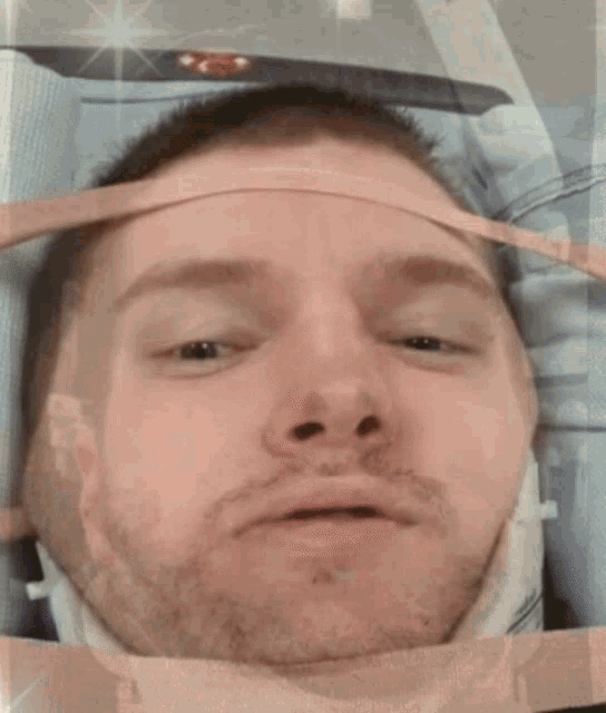 a close up of a man 's face with a surgical mask on