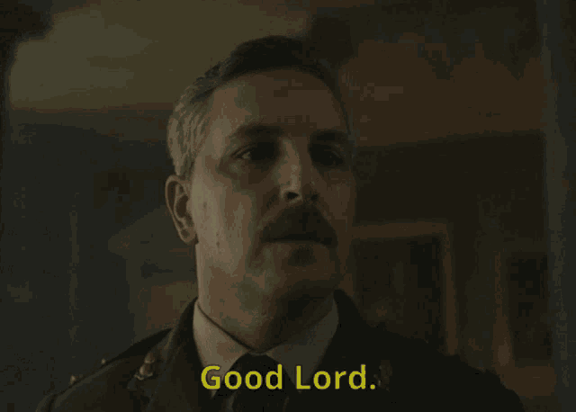 a man with a mustache says good lord in yellow letters