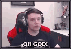 a man wearing headphones is sitting in front of a microphone and says `` oh god '' .