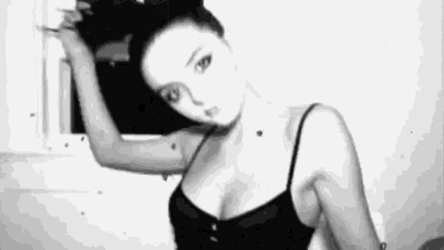 a black and white photo of a woman in lingerie .