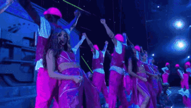 a group of people are dancing on a stage .