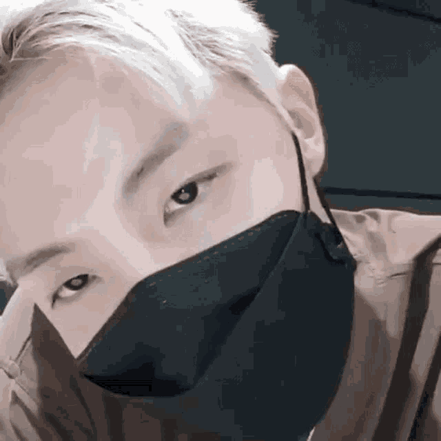 a close up of a man wearing a black mask .