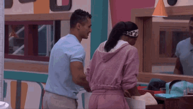 a man and a woman are standing next to each other