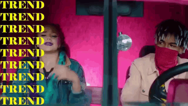 a man and a woman are sitting in a pink car with the word trend written on the bottom of the screen