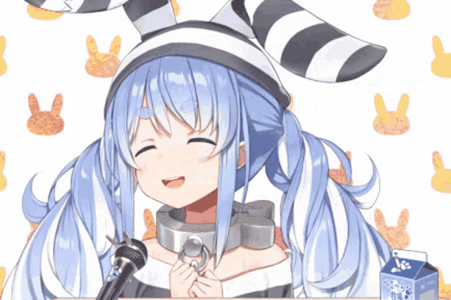 a girl with blue hair and a striped hat is smiling and holding a microphone
