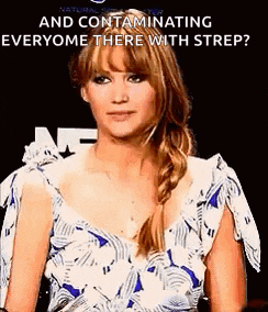 a woman in a blue and white dress is standing in front of a sign that says `` and contaminating everyone there with strip ? ''