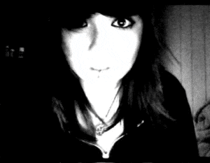 a black and white photo of a woman 's face and neck