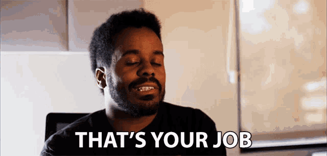a man with a beard says that 's your job with his eyes closed