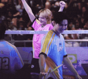 a man wearing a shirt that says sky is holding a tennis racket