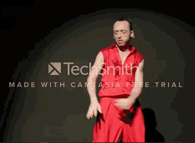 a man in a red shirt is dancing in front of a black background with techsmith made with camtasia free trial written on it