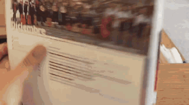 a person is holding a book that says dicembre