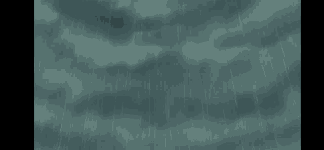 it looks like rain is falling on a cloudy sky .
