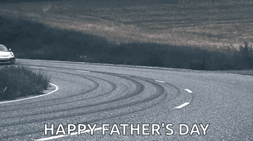 a car is driving down a road with the words happy father 's day