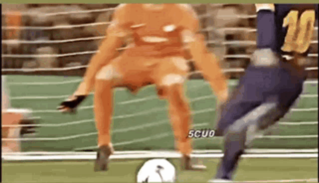 a soccer player wearing a number 10 jersey is kicking a soccer ball