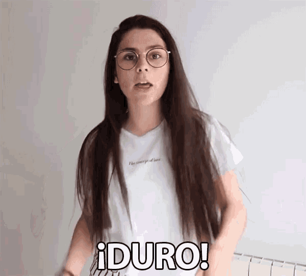 a woman wearing glasses and a white t-shirt says duro