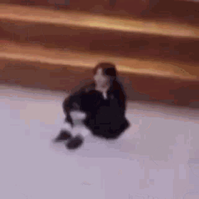 a person is sitting on top of a snow covered surface .