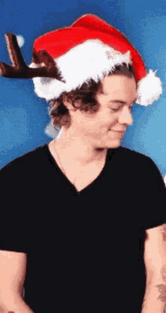 a man wearing a santa hat with reindeer antlers on his head