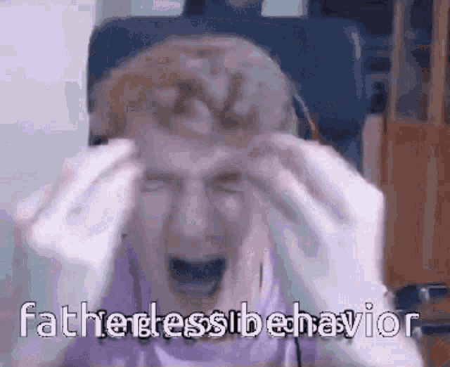 a man is sitting in a chair with his hands on his head and screaming .