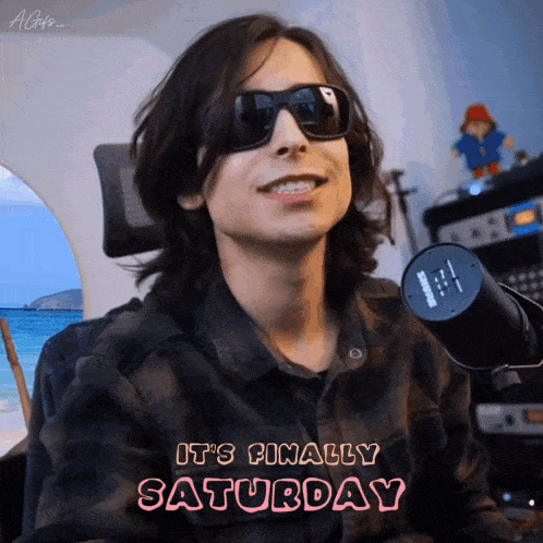 a man wearing sunglasses says it 's finally saturday in pink letters