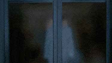 a man in a white suit is standing in a room with broken glass