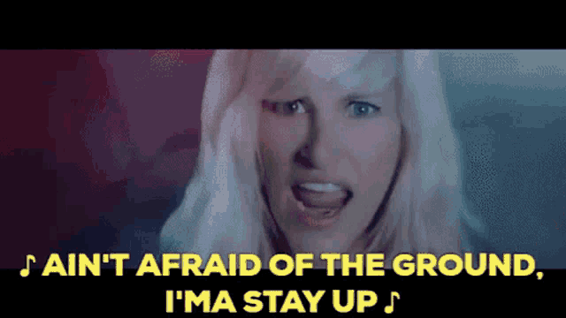 a woman singing a song that says ain 't afraid of the ground