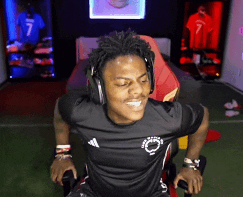 a man wearing headphones and a black shirt that says club world on it