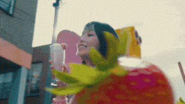 a woman in a strawberry costume is holding a glass of milk