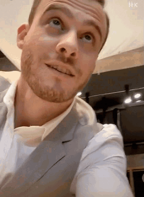a man with a beard wearing a suit and white shirt