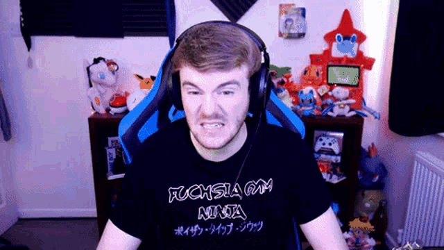 a man wearing headphones and a t-shirt that says " fuchsia gym ninja "
